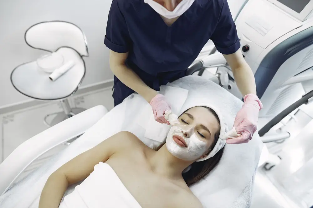 A client resting during a facial while a clinician works