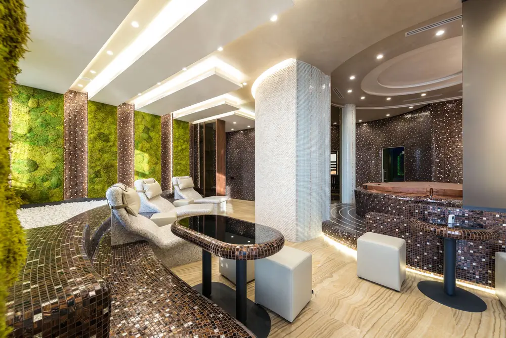 Spa-style treatment lounge with mosaic tiles and green wall