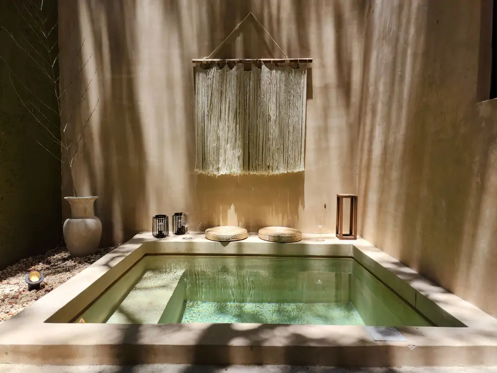 Calm treatment space with natural light and a soaking pool